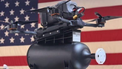 The Archer Fiber fiber-optic, FPV drone posed in front of the United States flag