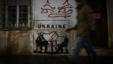 A mural titled 'Divided by Oligarchy' by anonymous Norwegian street artist Toddel, depicting US President Donald Trump and Russian President Vladimir Putin seated at a table next to a map of a divided Ukraine, is seen on a wall in Krakow, Poland, on January 29, 2026.