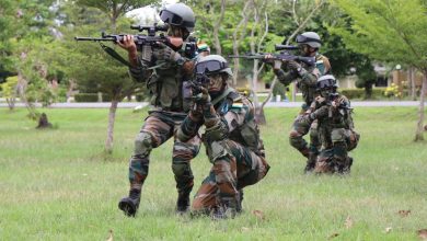 Soldiers in camouflage from the India practice shooting at a target, demonstrating precision and focus.