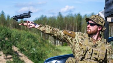 Personnel deploying a small unmanned aerial system