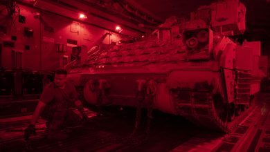U.S. Air Force Staff Sgt. David Altman, 15th Expeditionary Airlift Squadron flying crew chief, secures a U.S. Army Bradley Fighting Vehicle onto a C-17 Globemaster III at an undisclosed location, Southwest Asia, June 29, 2023. U.S. Air Forces Central uses the Globemaster III to support partners with a rapidly deployable airlift asset for combat operations across austere airfields to deter regional aggressors and to assure regional regional partners in the area of responsibility. (U.S. Air Force photo by Staff Sgt. Emily Farnsworth)