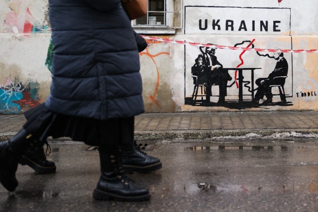 Street art stencil graffiti by Toddel, depicting Donald Trump and Vladimir Putin making a deal on Ukraine, is seen in Kazimierz district in Krakow, Poland on February 18th, 2026.
