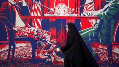 Iranians pass by the anti-American murals painted on the walls of the former embassy of the US in Tehran, Iran on April 16, 2025.