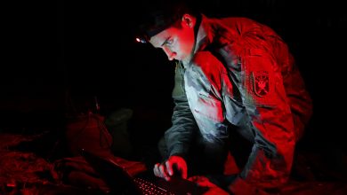 A student assigned to the U.S. Army John F. Kennedy Special Warfare Center and School, who is in the Special Forces Communications Sergeant course, uses a PDA-184 computer during nighttime antenna training at Fort Bragg, North Carolina August 30, 2019. The training qualified students in the high frequency communications module which trained them to be proficient in making, installing, operating and maintaining short-, medium-, and long-range antennas in order to communicate at long distances. (U.S. Army photo by K. Kassens)