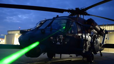 U.S. Air Force Master Sgt. Miguel Gibson, 31st Fighter Wing flight safety manager, demonstrates how pointing a laser at an HH-60 Pave Hawk can illuminate the cockpit at Aviano Air Base, Italy, October 12, 2023. Laser strikes on aircraft, often referred to as "lasing," have become a growing concern for aviation safety in recent years, as it can cause blindness, distraction and potential long-term eye damage to pilots and crew members. (U.S. Air Force photo by Airman 1st Class Hannah Stubblefield)