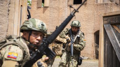 Ecuadorian Naval Infantry Corps marines and U.S. Marines assigned to Bravo Company, Battalion Landing Team 1/5, 15th Marine Expeditionary Unit, egress from the infantry immersion trainer upon completion at Marine Corps Training Area Bellows, Waimanalo, Hawaii, during Exercise Rim of the Pacific (RIMPAC) 2024, July 3. Twenty-nine nations, 40 surface ships, three submarines, 14 national land forces, more than 150 aircraft and 25,000 personnel are participating in RIMPAC in and around the Hawaiian Islands, June 27 to Aug. 1. The world's largest international maritime exercise, RIMPAC provides a unique training opportunity while fostering and sustaining cooperative relationships among participants critical to ensuring the safety of sea lanes and security on the world's oceans. RIMPAC 2024 is the 29th exercise in the series that began in 1971. (U.S. Marine Corps photo by Cpl. Luis Agostini)