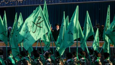 Iranian soldiers carrying green flags march past a reviewing stand holding Iranian Supreme Leader Ayatollah Ali Khamenei and senior military commanders during a ceremony in Shahrud, Iran, on November 11, 2006. Iranian Supreme Leader Ayatollah Ali Khamenei attended the joint military ceremony at the base of the 58th Takavar Division to review provincial armed forces units and observe tactical training exercises. (Photo by Hossein Fatemi / Middle East Images via AFP)