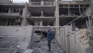 An Iranian man stands in front of destroyed buildings near a police headquarters that is completely destroyed in U.S.-Israeli attacks in Tehran, Iran, on March 2, 2026.