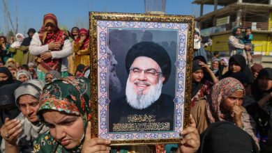 A Shiite Muslim woman holds a portrait of the late leader of the Lebanese group Hezbollah, Hassan Nasrallah, during a protest against the killing of Iran's Supreme Leader Ayatollah Ali Khamenei in Shadipora, Sumbal area of Bandipora District, north of Srinagar, Jammu and Kashmir, on March 3, 2026.