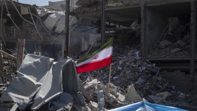 A national flag is photographed on the ruins of a police station that is struck during US-Israeli attacks in Tehran, Iran, on March 3, 2026.
