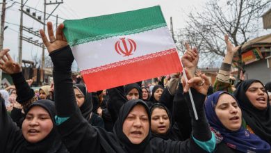 A Shiite Muslim woman holds an Iranian flag as she shouts anti-US and anti-Israel slogans during a protest against the killing of Iran's Supreme Leader Ayatollah Ali Khamenei on the outskirts of Srinagar, Jammu and Kashmir, on March 4, 2026.
