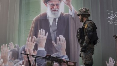 An armed Iranian policeman monitors an area while standing on an armored vehicle in front of a portrait of Iran's late Supreme Leader Ayatollah Ali Khamenei, who is killed in a U.S.-Israeli military campaign in Tehran, Iran, on March 7, 2026.