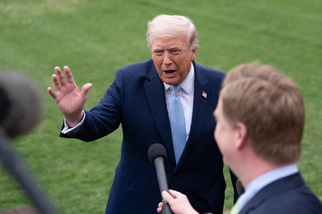 US President Donald Trump speaks to members of the media on the South Lawn of the White House before boarding Marine One for a trip to Florida in Washington, D.C., on March 20, 2026.
