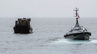 An autonomous surface vessel sea drone intercepts a cargo boat during a UK maritime security operation on open water