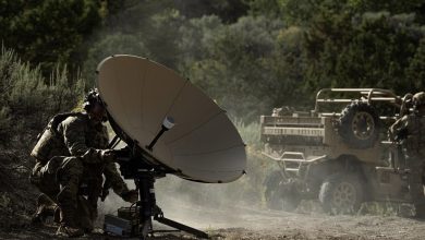 Soldier preparing a deployable satellite