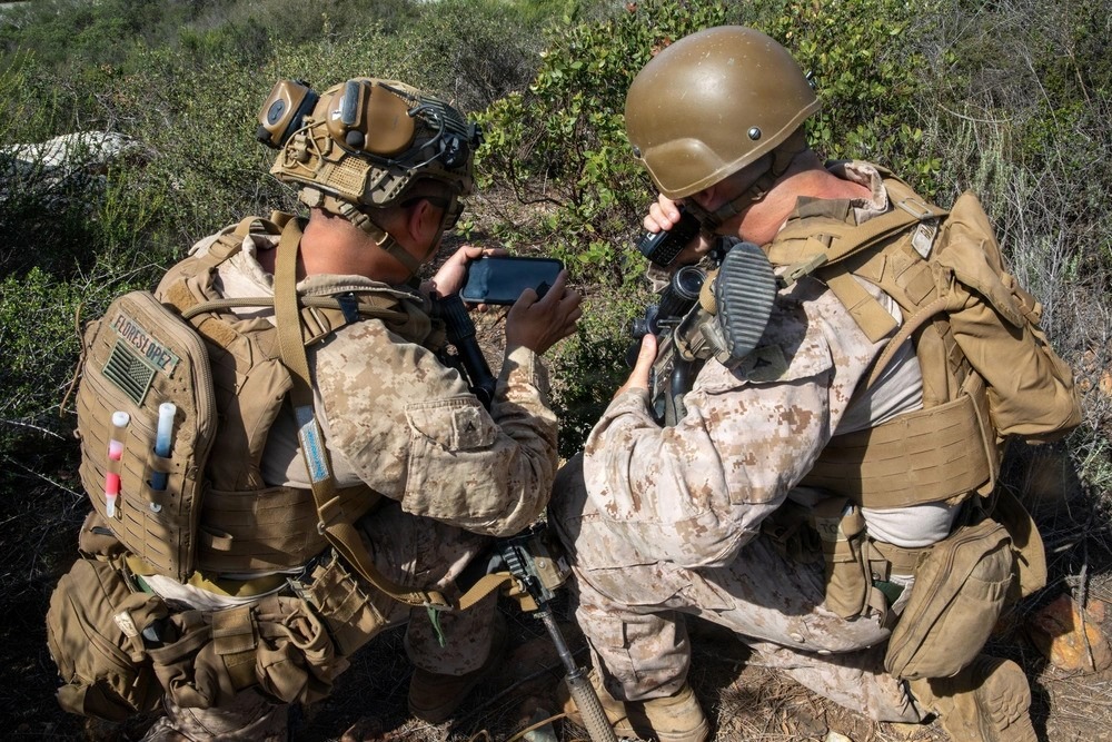 Two soldiers use a Defense Advanced Global Positioning System Receiver.