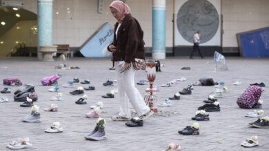 A woman walks through an installation symbolizing the Shajareh Tayyebeh School in Minab, which was destroyed in an airstrike, in a business district of Tehran, Iran, on April 22, 2026, as a ceasefire is extended.