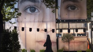 A banner depicting a portrait of a schoolgirl during a rally in northern Tehran, Iran, on May 2, 2026. The rally takes place as a ceasefire is extended