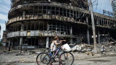 Children walk past a heavily damaged shopping center in Kyiv, Ukraine, on May 24, 2026, after Russian strikes.