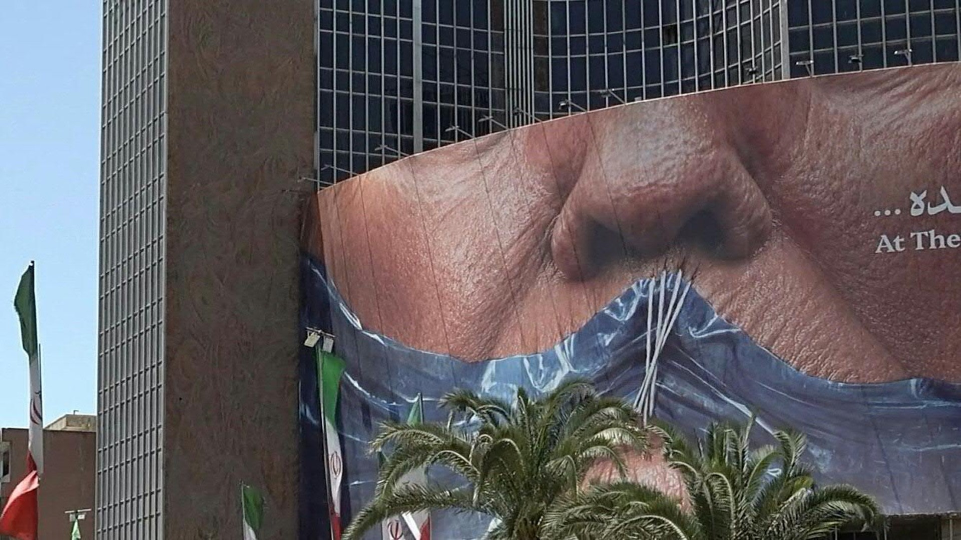 Daily life in Tehran during Eid al-Adha, with shoppers, traffic and Iranian flags seen near a large anti-US billboard showing US President Donald Trump, the Strait of Hormuz and the words "at the breaking point", as Iran and the United States appear to be edging towards a possible deal to end the war.