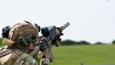 Personnel targeting a drone with fire control-equipped weapon