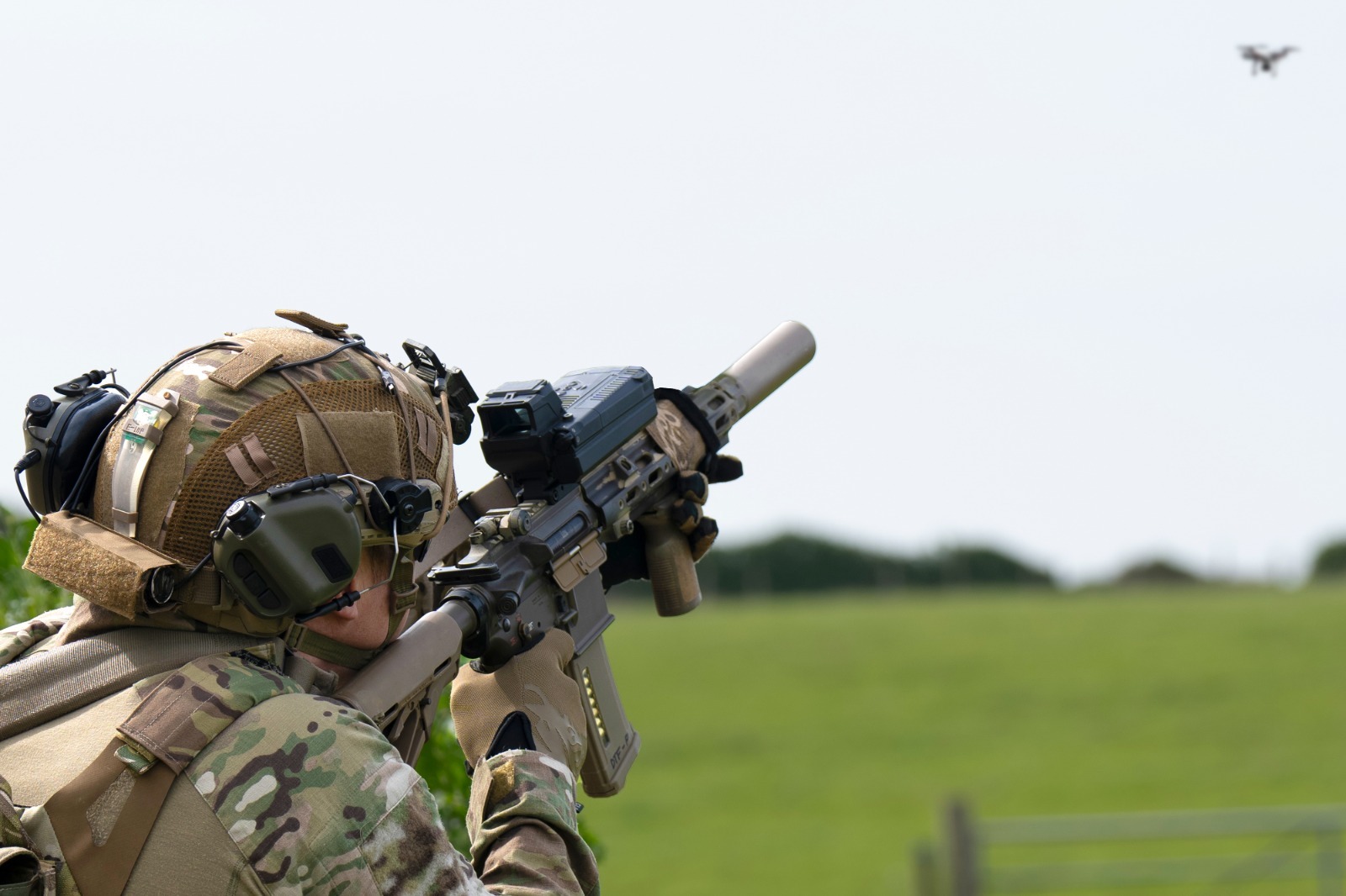 Personnel targeting a drone with fire control-equipped weapon