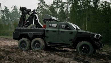 Inguar 4 military recovery vehicle with a rear-mounted lifting crane traversing muddy off-road terrain, designed for frontline equipment rescue operations