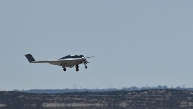 Northrop Grumman XRQ-73 experimental stealth drone on its first flight with landing gear down over an arid landscape