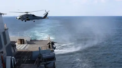 U.S. Navy destroyer USS Roosevelt transits the Strait of Hormuz, a strategic maritime chokepoint where low-cost asymmetric threats could disrupt global shipping and energy flows.