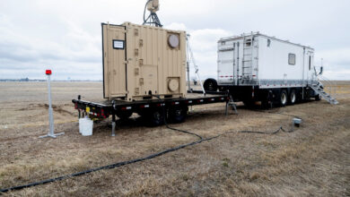 US Naval Research Laboratory mobile laser system on flatbed trailer deployed in field, used for power beaming and counter-UAS operations