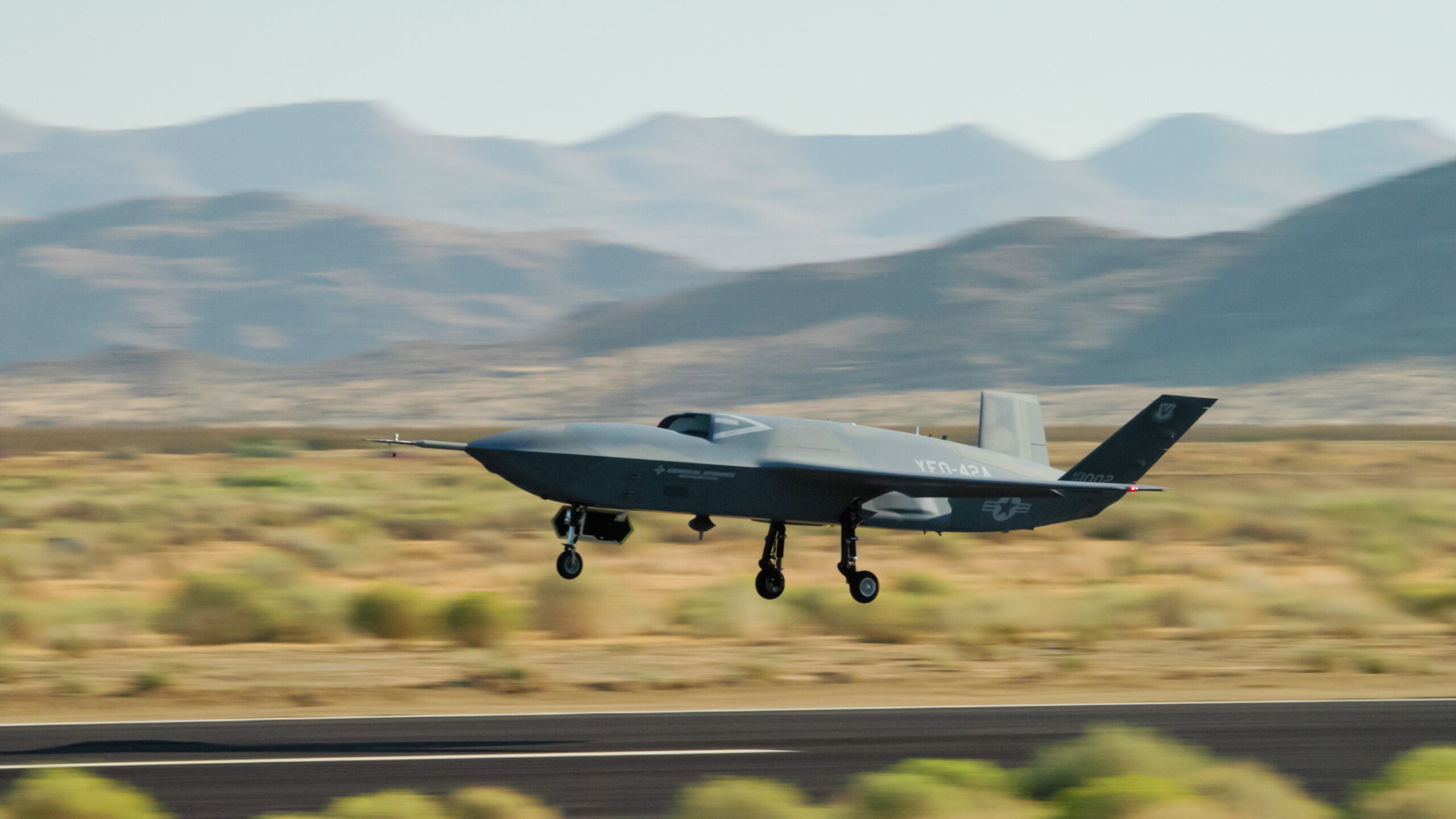 A YFQ-42A Collaborative Combat Aircraft takes off during flight testing at a California test location. The aircraft was developed in partnership with General Atomics as part of the Air Force’s effort to accelerate delivery of affordable, semi-autonomous aircraft.