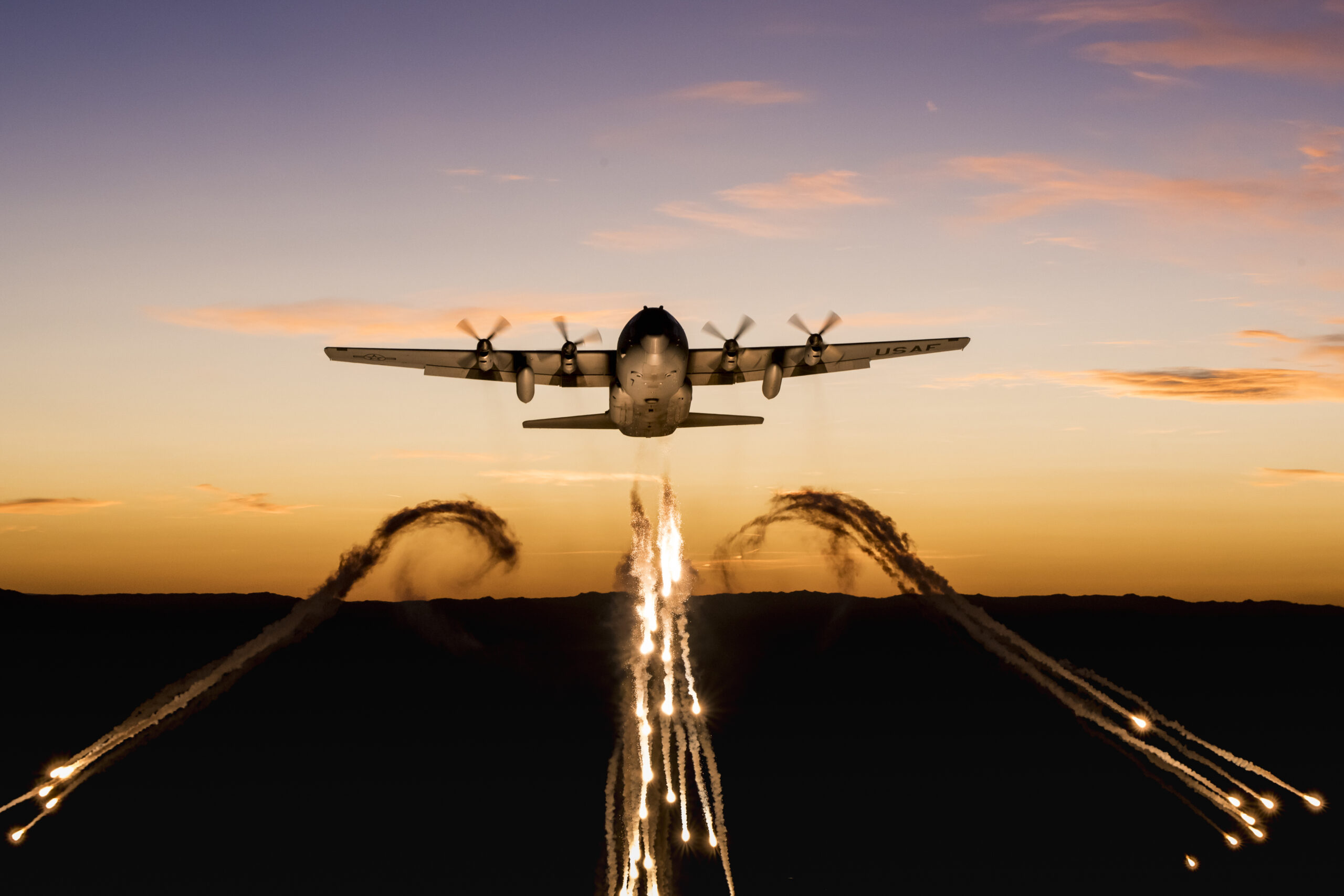 A C-130 from the 153rd Airlift Wing, Wyoming Air National Guard, fires off flares over Camp Guernsey Joint Training Center during a training mission on Sept. 24, 2019. The 153rd Airlift Wing's primary mission is to provide combat airlift to our state and nation. (U.S. Air National Guard photo by Staff Sgt. Jon Alderman)