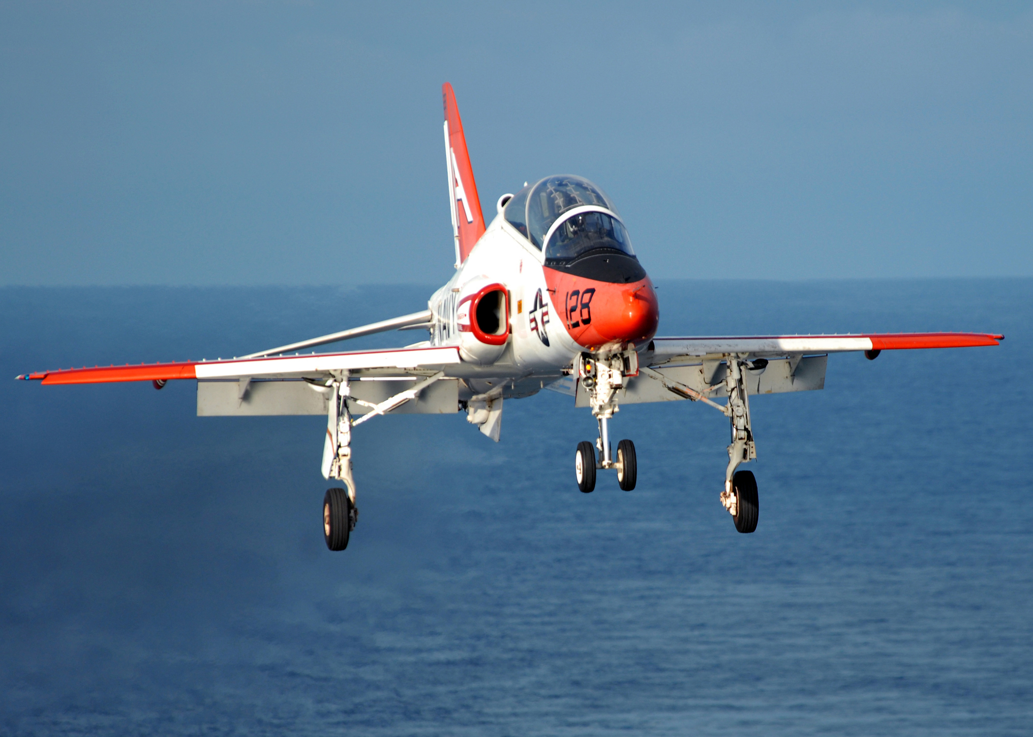 A T-45C Goshawk prepares to land on the flight deck of aircraft carrier USS Dwight D. Eisenhower. The Navy uses the T-45 to train new pilots for carrier-based operations.