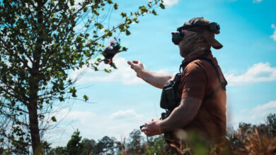 An Unmanned Aerial Vehicle (UAV) drone operator assigned to 1st Special Forces Command (Airborne) releases a UAV for a flight demonstration at a counter- drone range in Ellerbe, North Carolina, May 5, 2026. UAVs are flown using First Person View (FPV) goggles to see real-time, immersive video feed from the drone's internal camera. This photo has been altered to protect the identity of the operator. (U.S. Army photo by Ssg. Gabriel E. Davis)