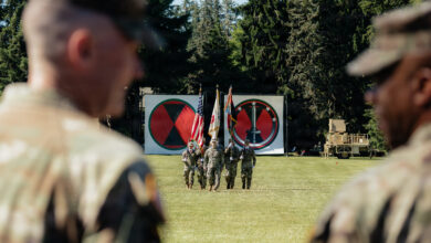 Maj. Gen. Bernard Harrington, 7th Infantry Division (Multi-Domain Command - Pacific) Commanding General (left), and Gen. Ronald Clark, U.S. Army Pacific Commanding General (right), look on as Col. Andrew Gallo, 7th Infantry Division (Multi-Domain Command - Pacific) Chief of Staff (center), marches the color guard during the 7th ID (MDC-PAC) redesignation ceremony at Joint Base Lewis-McChord, Wash., June 18, 2026. The redesignation honors the Bayonet Division’s legacy while establishing 7th ID (MDC-PAC) as the Army’s newest theater-enabling command, built to integrate maneuver, fires, air defense, cyber, space, electronic warfare, intelligence, unmanned systems, sustainment, and command and control in support of the Joint Force across the Pacific. (U.S. Army photo by Staff Sgt. Cayce Watson)