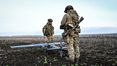 Soldiers carry a drone before launch in the Zaporizhzhia region.