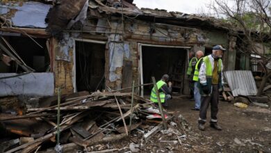 People in high-visibility vests clear debris after a Russian drone strike in Odesa, Ukraine, on June 1, 2026.