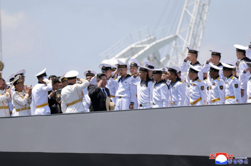 North Korean leader Kim Jong Un salutes naval personnel aboard the Choe Hyon destroyer during its commissioning ceremony in Nampho, North Korea.