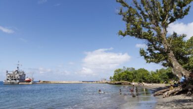 The port, a ship, and inhabitants on the beach of Lenakel, the main city on the island of Tanna in the south of the Vanuatu archipelago