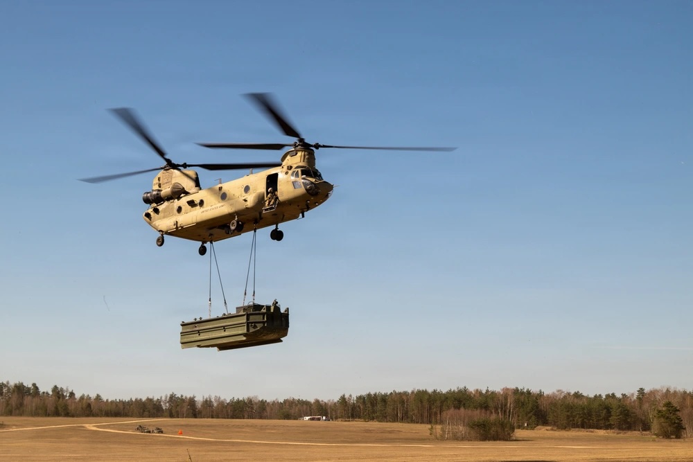 A US Army CH-47F Chinook transports bridging equipment during a sling load operation in Germany. Photo: Staff Sgt. Jamie Robinson/DVIDS