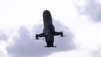 The Ukrainian F-Drones LITAVR fully autonomous copter-type interceptor drone hovering vertically against a cloudy sky during air defense field tests.