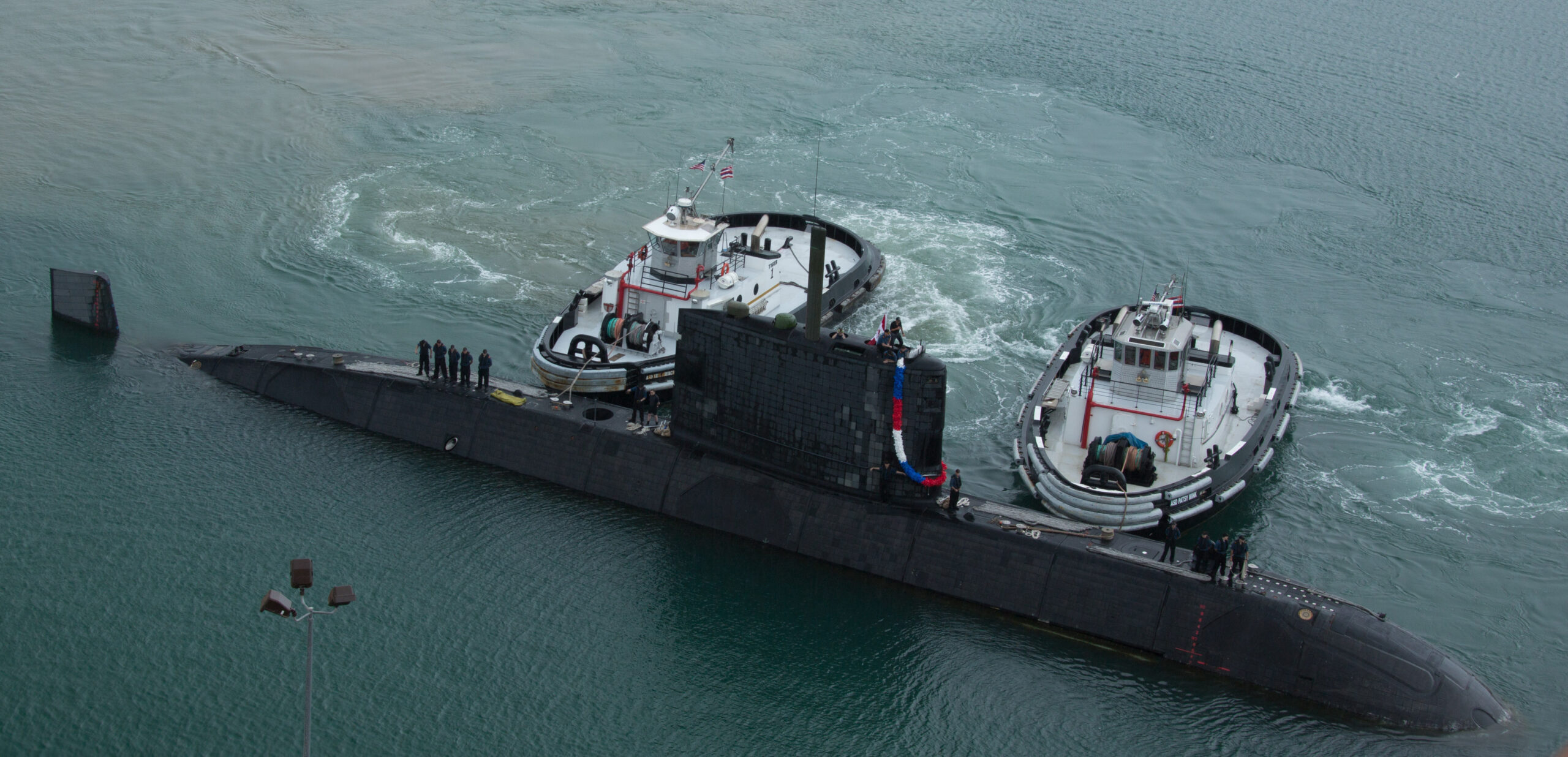 Her Majesty's Canadian Submarine (HMCS) Victoria arriving in rainy morning at Pearl Harbor, Hawaii. Twenty-two nations, more than 40 ships and submarines, more than 200 aircraft and 25,000 personnel are participating in RIMPAC exercise from June 29 to Aug. 3, in and around the Hawaiian islands. The world's largest international maritime exercise, RIMPAC provides a unique training opportunity that helps participants foster and sustain the cooperative relationships that are critical to ensuring the safety of sea lanes and security on the world's oceans. RIMPAC 2012 is the 23rd exercise in the series that began in 1971. (Photo by: Jacek Szymanski)