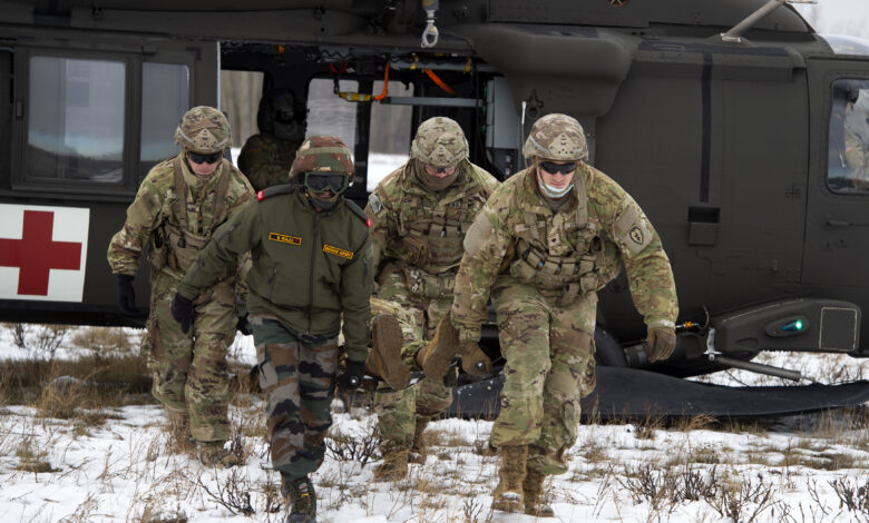 U.S. Army paratroopers assigned to the 1st Squadron, 40th Cavalry Regiment (Airborne), 4th Infantry Brigade Combat Team (Airborne), 25th Infantry Division, and an Indian Army soldier assigned to the 7th Battalion, the Madras Regiment, offload a patient while conducting medical evacuation training during exercise Yudh Abhyas 21 at Joint Base Elmendorf-Richardson, Alaska Oct. 19, 2021. The Alaska Army National Guard’s 2-211th General Support Aviation Battalion provided air support for the training. Yudh Abhyas 21 reinforces our commitment to the Indo-Pacific region and improves interoperability with our Indian Army partners-this is the 17th iteration of Exercise Yudh Abhyas since its inception in 2004. (U.S. Air Force photo by Alejandro Peña)