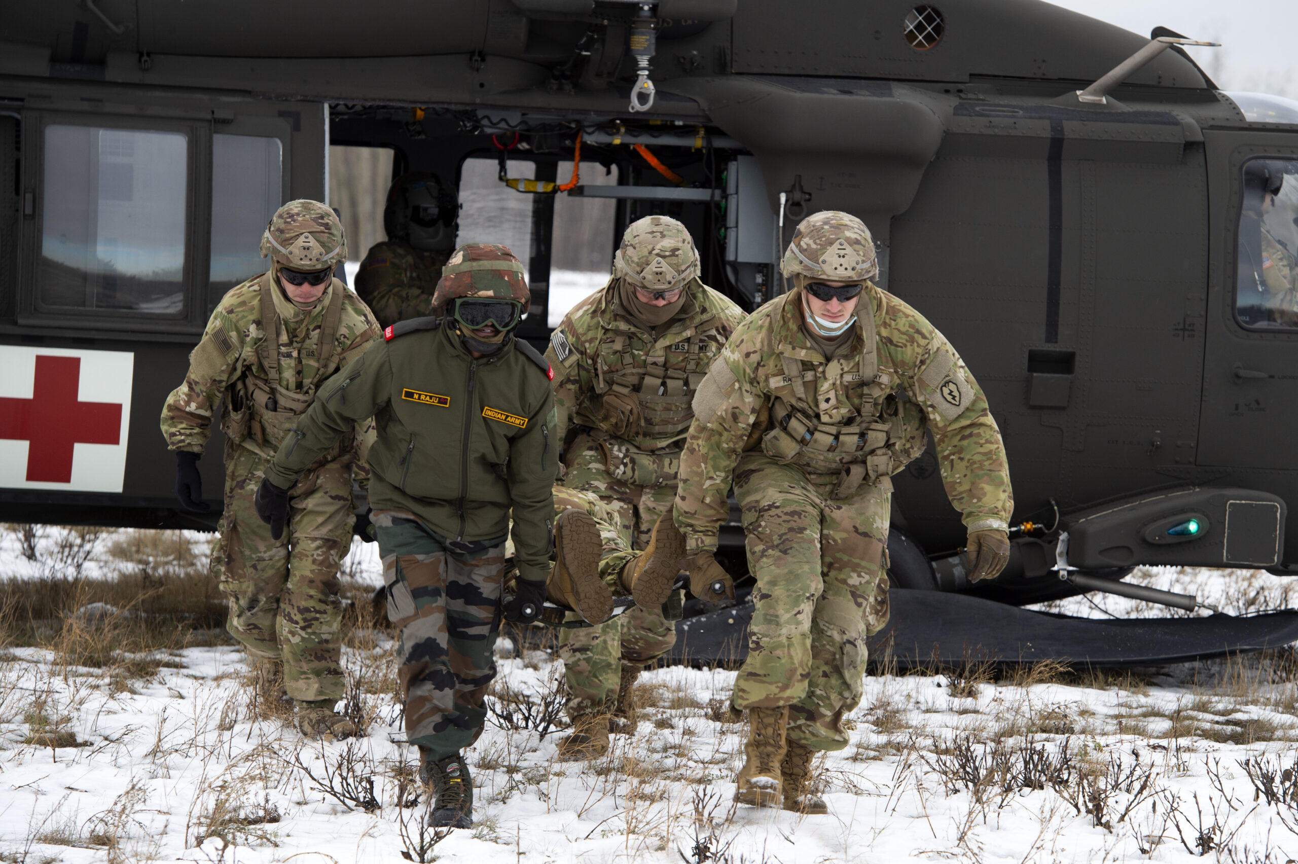 U.S. Army paratroopers assigned to the 1st Squadron, 40th Cavalry Regiment (Airborne), 4th Infantry Brigade Combat Team (Airborne), 25th Infantry Division, and an Indian Army soldier assigned to the 7th Battalion, the Madras Regiment, offload a patient while conducting medical evacuation training during exercise Yudh Abhyas 21 at Joint Base Elmendorf-Richardson, Alaska Oct. 19, 2021. The Alaska Army National Guard’s 2-211th General Support Aviation Battalion provided air support for the training. Yudh Abhyas 21 reinforces our commitment to the Indo-Pacific region and improves interoperability with our Indian Army partners-this is the 17th iteration of Exercise Yudh Abhyas since its inception in 2004. (U.S. Air Force photo by Alejandro Peña)