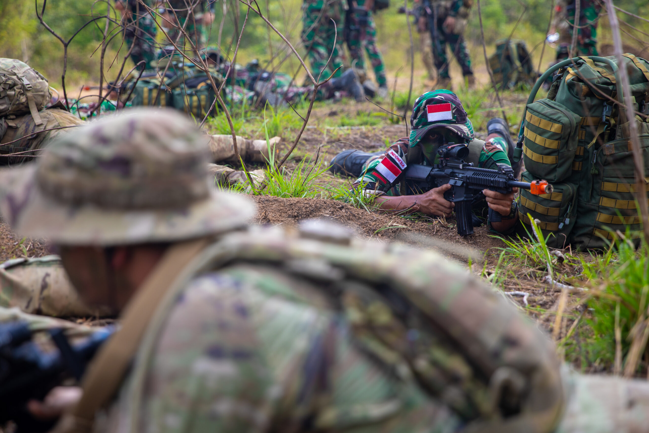 U.S. Army Soldiers assigned to the 11th Airborne Division, 1st Brigade Combat Team, Fort Wainwright, Alaska, and Indonesian soldiers assigned to the Indonesian Army Strategic Reserve Command, hold a secure position at the Jungle Field Training Exercise during Super Garuda Shield 25 in Baturaja, Indonesia, Aug. 29, 2025. Super Garuda Shield is an annual exercise between the Indonesian National Armed Forces and the U.S. military designed to strengthen bilateral interoperability, capabilities and cooperation. (U.S. Army photo by Spc. John Farmer)