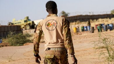 A Malian soldier walks through a military position in Boulikessi, Mali.