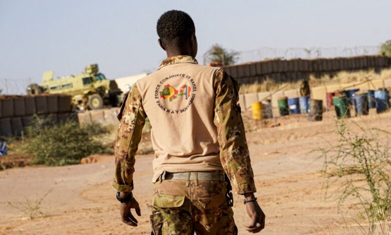 A Malian soldier walks through a military position in Boulikessi, Mali.