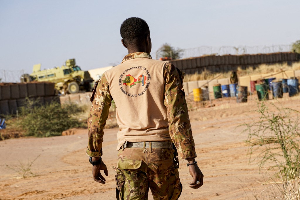 A Malian soldier walks through a military position in Boulikessi, Mali.