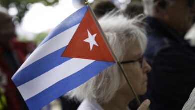 A woman holds a Cuban flag in Paris, France, on 11 June 2026.