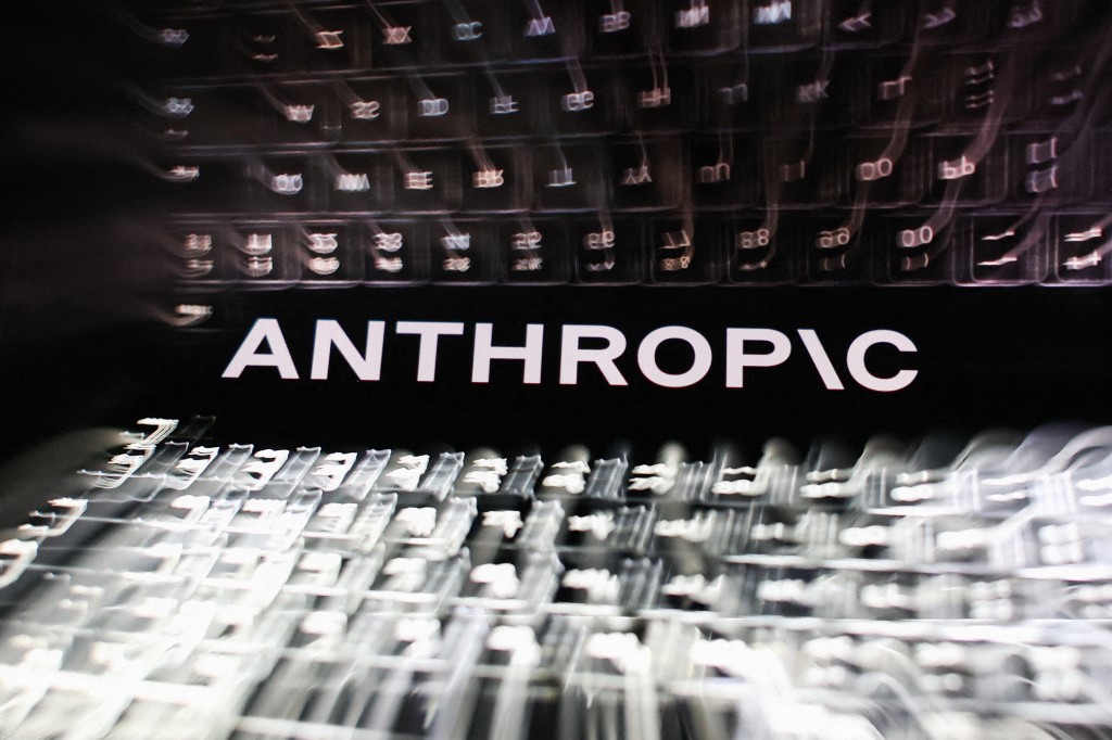 The Anthropic logo is displayed on a smartphone screen in front of a laptop keyboard in a multiple-exposure illustration taken in Krakow, Poland, on June 29, 2026. Anthropic said three of its Claude AI models gained unauthorized access to external organizations during security testing due to a testing environment error. (Photo: Jakub Porzycki/NurPhoto via AFP)